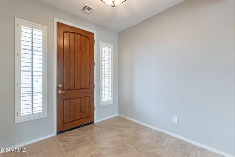an empty room with windows and closet