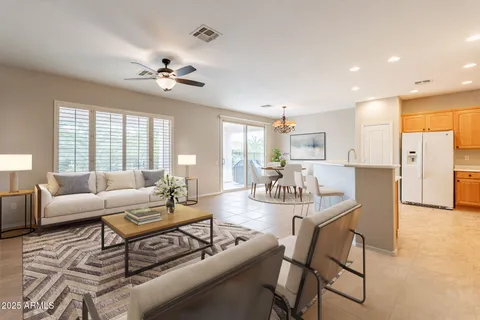 a living room with furniture dining table and a chandelier