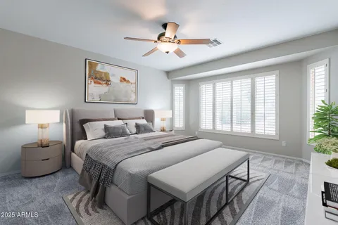 a spacious bedroom with a bed a chandelier and a window