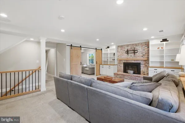 a living room with furniture fireplace and a fireplace