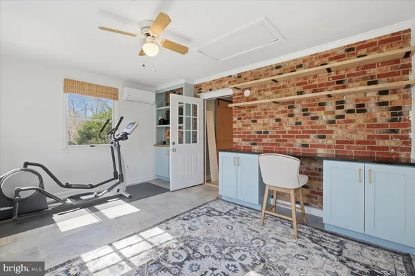 a living room with furniture and a table with a bookshelf