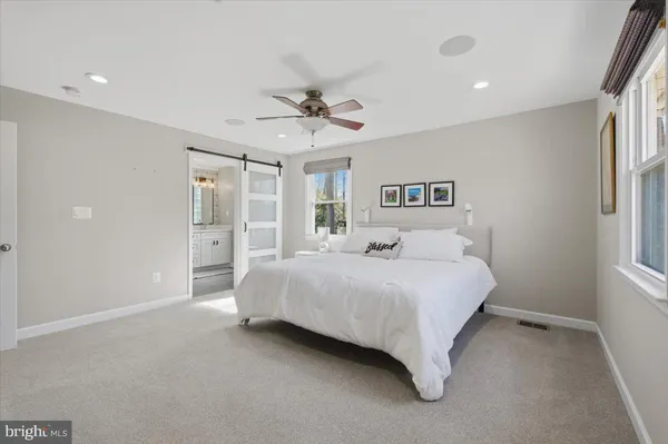 a bedroom with a large bed and a chandelier