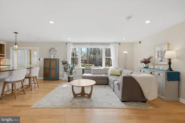 a living room with furniture a rug and a table