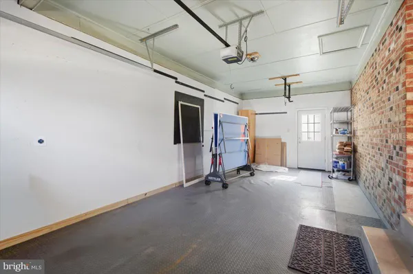 a view of a backyard with table and chairs and wooden fence