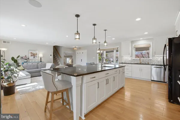 a kitchen with stainless steel appliances granite countertop a sink and cabinets