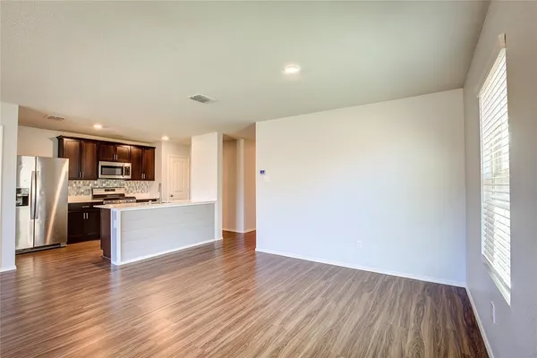 a view of kitchen with wooden floor and electronic appliances
