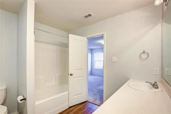 a bathroom with a tub sink and shower