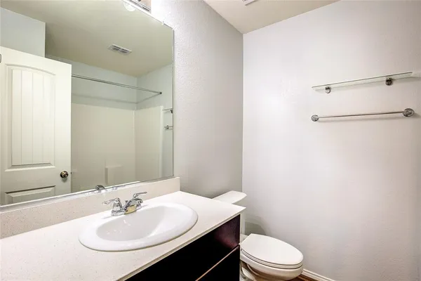 a bathroom with a sink toilet and a mirror
