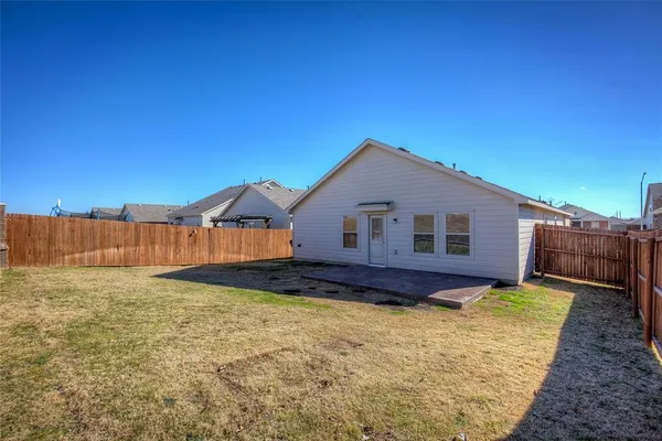 a view of a house with wooden fence