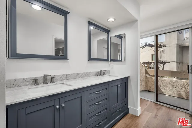 a bathroom with a double vanity sink and mirror