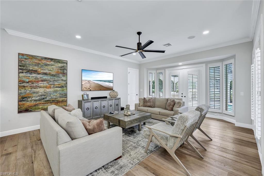 4624 Pond Apple Drive North Naples, FL 34119 - Photo 11 of 46 a living room with furniture and a large window