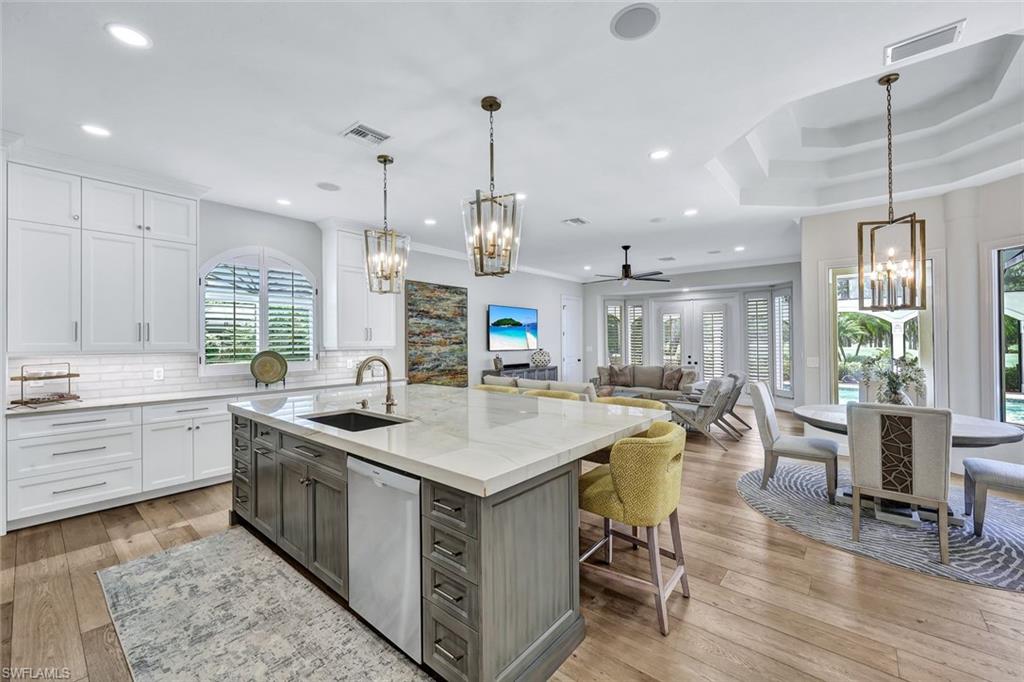 4624 Pond Apple Drive North Naples, FL 34119 - Photo 15 of 46 a kitchen with sink stove and center island
