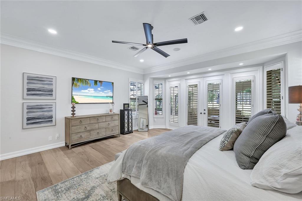 4624 Pond Apple Drive North Naples, FL 34119 - Photo 24 of 46 a bedroom with a bed and a dresser