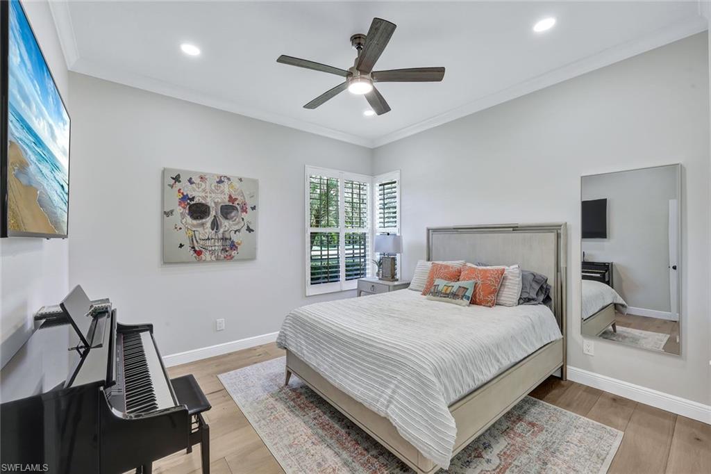 4624 Pond Apple Drive North Naples, FL 34119 - Photo 25 of 46 a bedroom with a large bed and a window