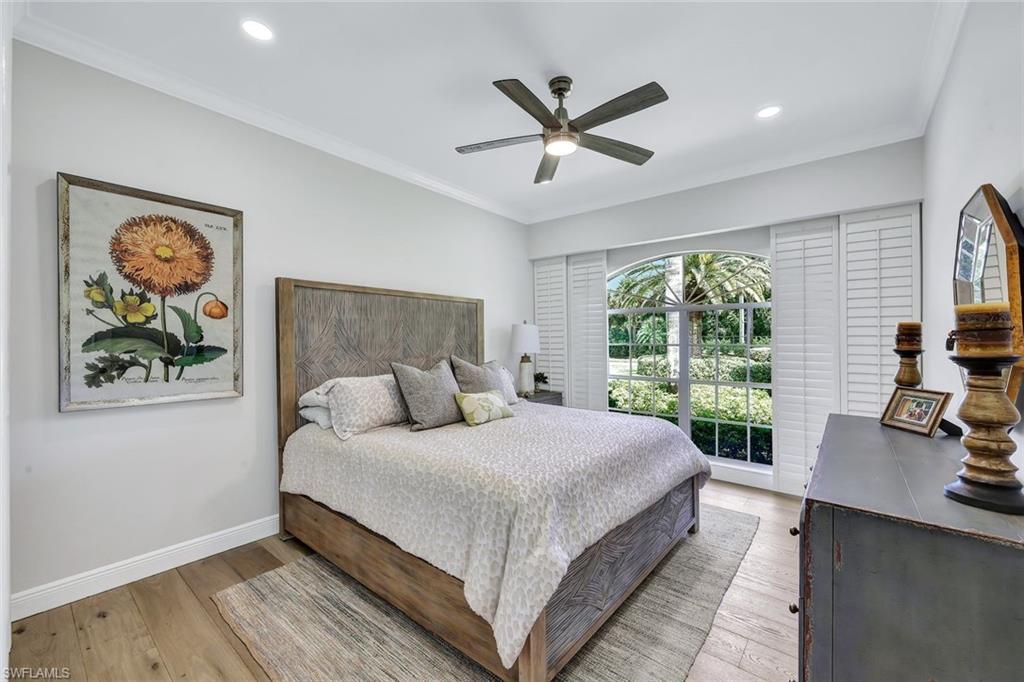 4624 Pond Apple Drive North Naples, FL 34119 - Photo 27 of 46 a large bedroom with a bed and a large window