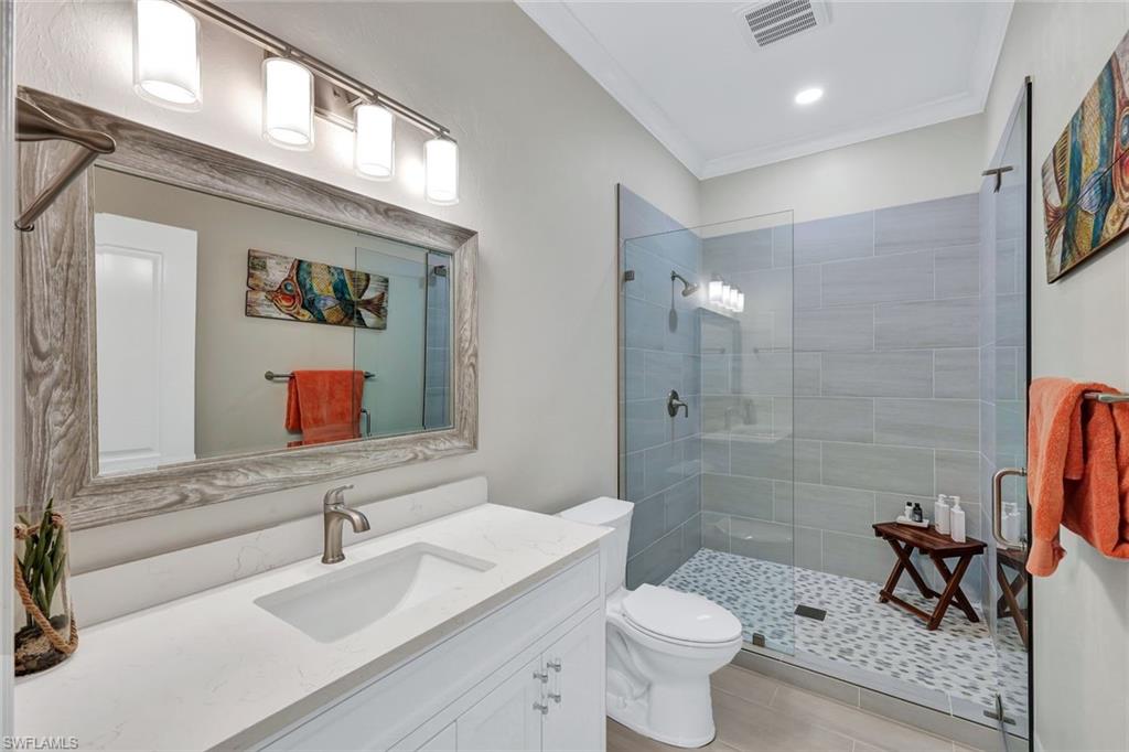 4624 Pond Apple Drive North Naples, FL 34119 - Photo 28 of 46 a bathroom with a sink toilet and shower