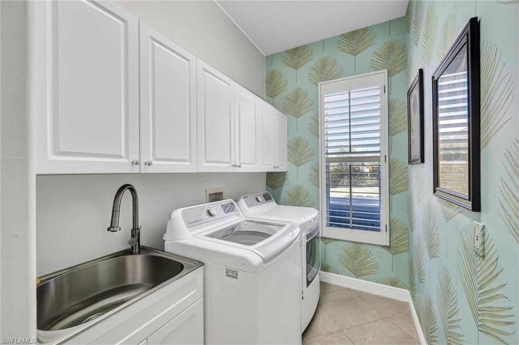 4624 Pond Apple Drive North Naples, FL 34119 - Photo 30 of 46 a kitchen with a sink and cabinets