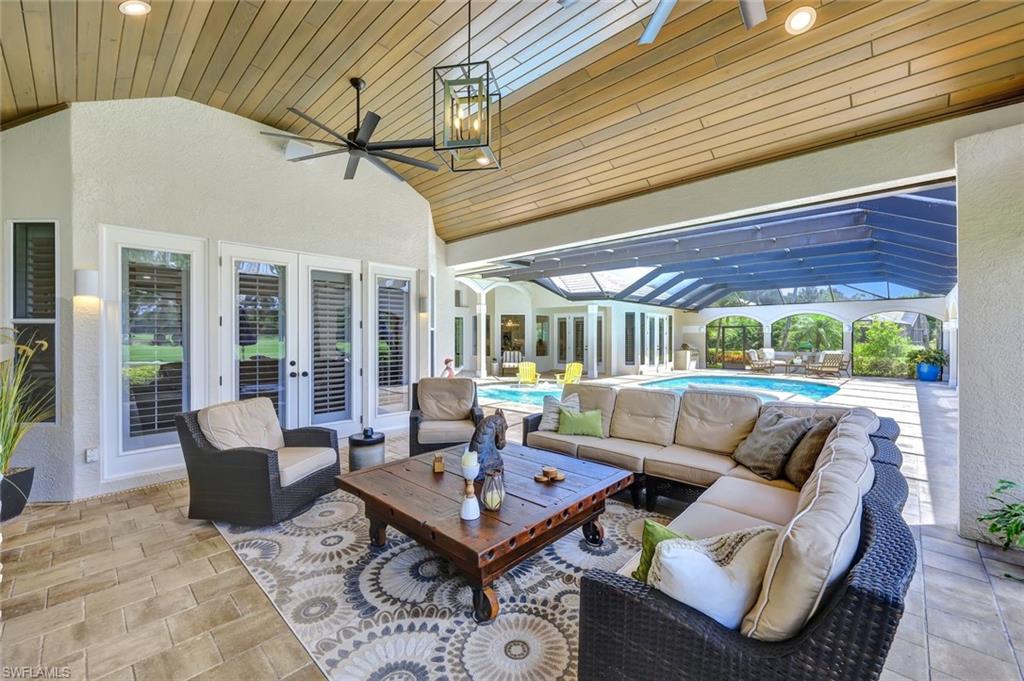 4624 Pond Apple Drive North Naples, FL 34119 - Photo 31 of 46 a living room with furniture and a large window