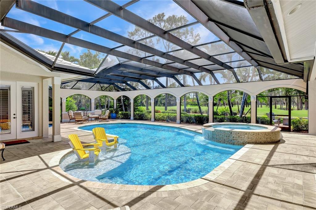 4624 Pond Apple Drive North Naples, FL 34119 - Photo 34 of 46 a view of swimming pool with sitting area