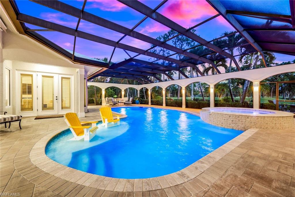 4624 Pond Apple Drive North Naples, FL 34119 - Photo 35 of 46 a view of a swimming pool with a patio