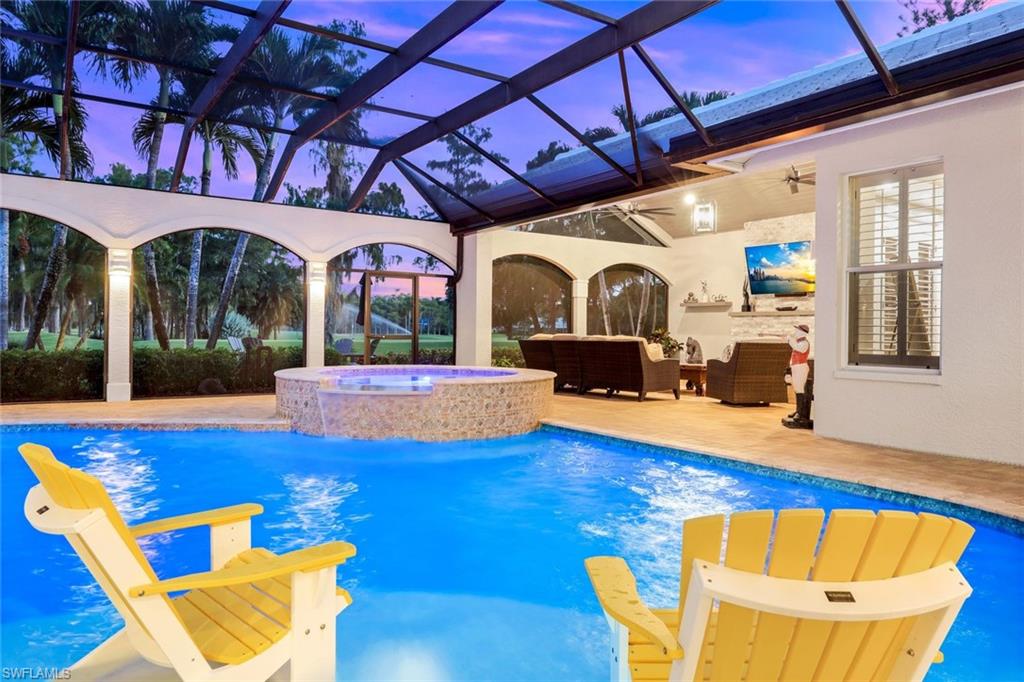 4624 Pond Apple Drive North Naples, FL 34119 - Photo 36 of 46 a view of a patio with table and chairs with wooden floor and plants