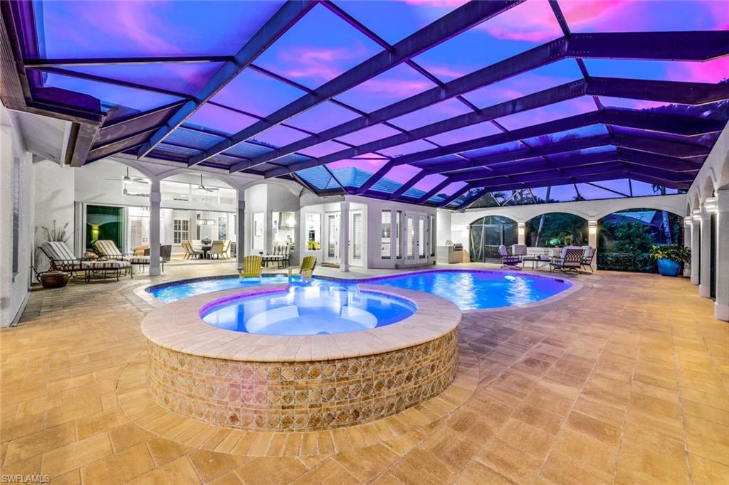 4624 Pond Apple Drive North Naples, FL 34119 - Photo 38 of 46 a view of a swimming pool with a patio