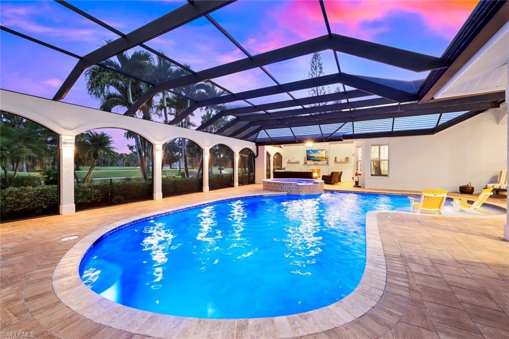 4624 Pond Apple Drive North Naples, FL 34119 - Photo 41 of 46 a view of a swimming pool with a patio