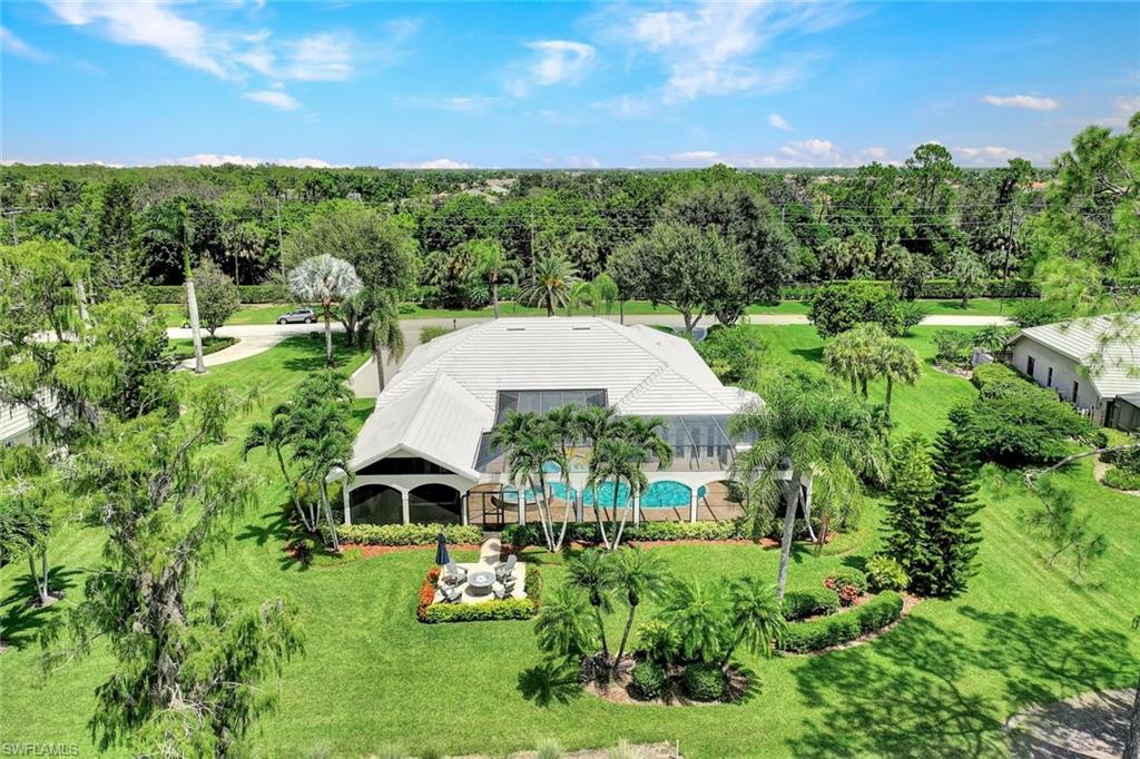 4624 Pond Apple Drive North Naples, FL 34119 - Photo 42 of 46 a aerial view of a house with a big yard