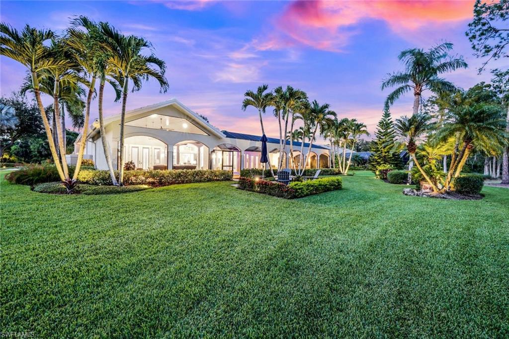 4624 Pond Apple Drive North Naples, FL 34119 - Photo 43 of 46 a front view of a house with garden