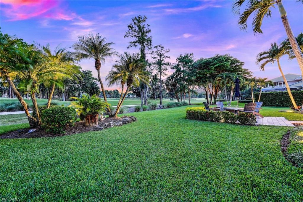 4624 Pond Apple Drive North Naples, FL 34119 - Photo 44 of 46 a view of a yard with a table and chairs
