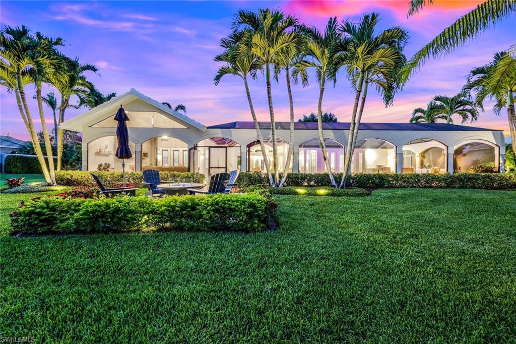 4624 Pond Apple Drive North Naples, FL 34119 - Photo 46 of 46 a front view of a house with a garden