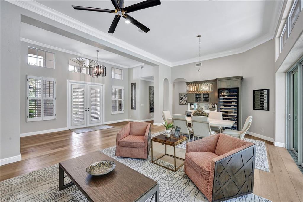 4624 Pond Apple Drive North Naples, FL 34119 - Photo 7 of 46 a living room with furniture and wooden floor
