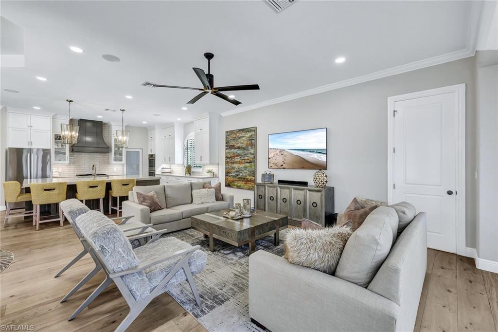 4624 Pond Apple Drive North Naples, FL 34119 - Photo 8 of 46 a living room with furniture kitchen and a chandelier