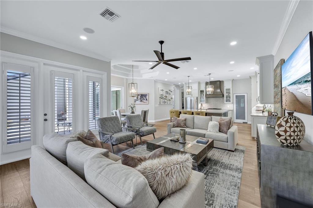 4624 Pond Apple Drive North Naples, FL 34119 - Photo 9 of 46 a living room with furniture kitchen view and a large window