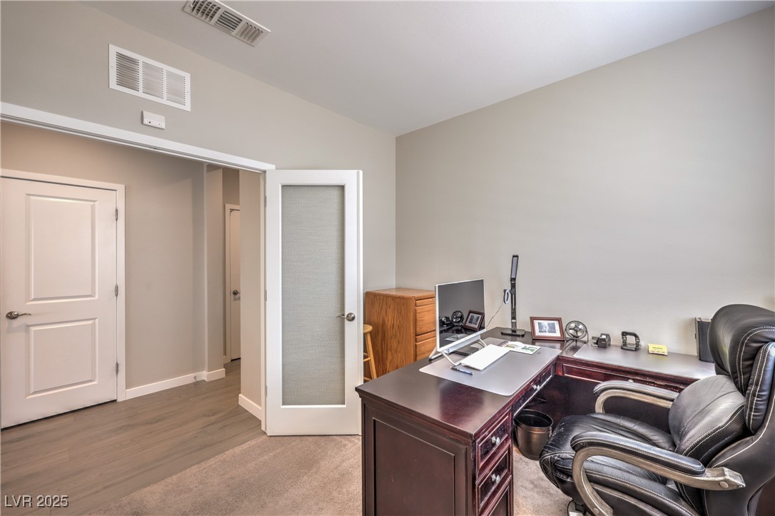 2711 Evolutionary Lane Las Vegas, NV 89138 - Photo 17 of 37 Office with vaulted ceiling, light wood finished floors, and baseboards