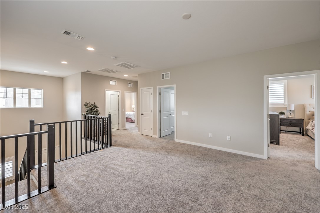 2711 Evolutionary Lane Las Vegas, NV 89138 - Photo 20 of 37 Unfurnished room with light carpet, plenty of natural light, recessed lighting, and baseboards