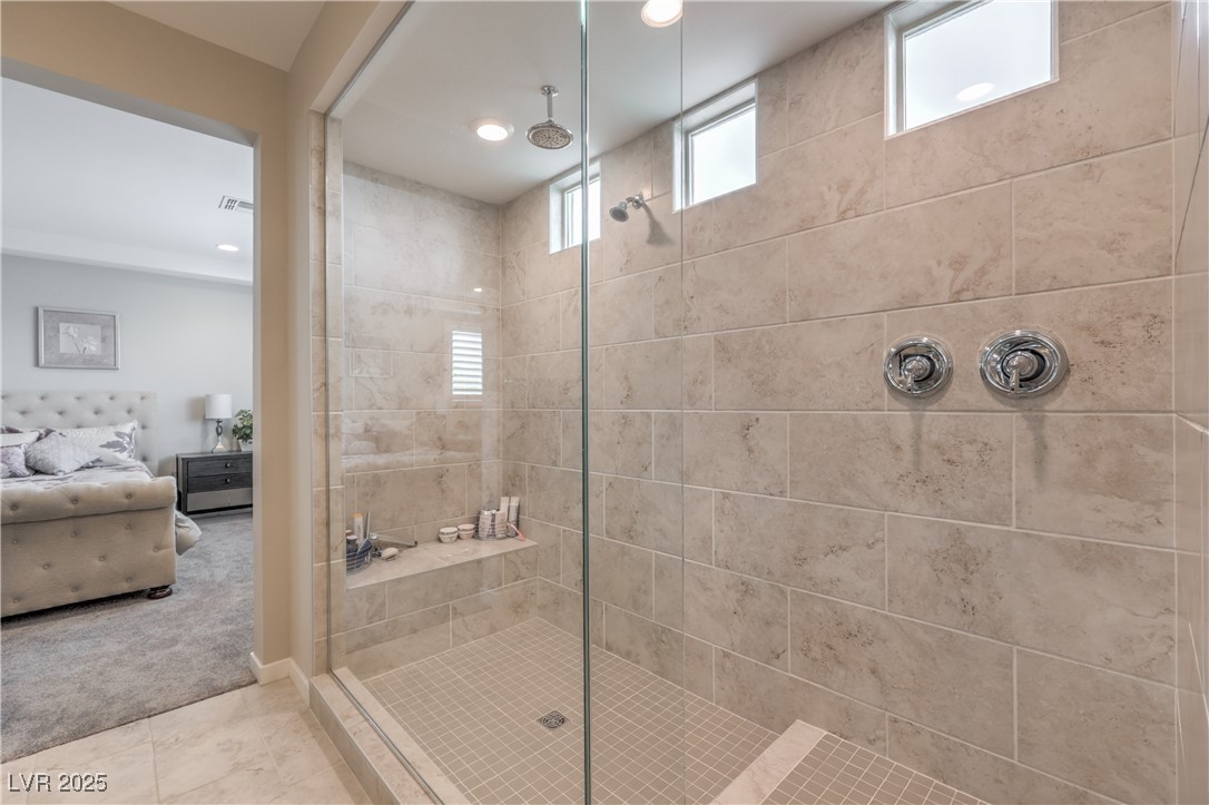 2711 Evolutionary Lane Las Vegas, NV 89138 - Photo 26 of 37 Ensuite bathroom with tiled shower, recessed lighting, and tile patterned floors
