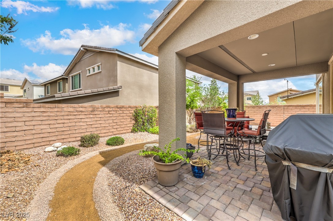 2711 Evolutionary Lane Las Vegas, NV 89138 - Photo 35 of 37 Fenced backyard with a patio area, outdoor dining area, and grilling area