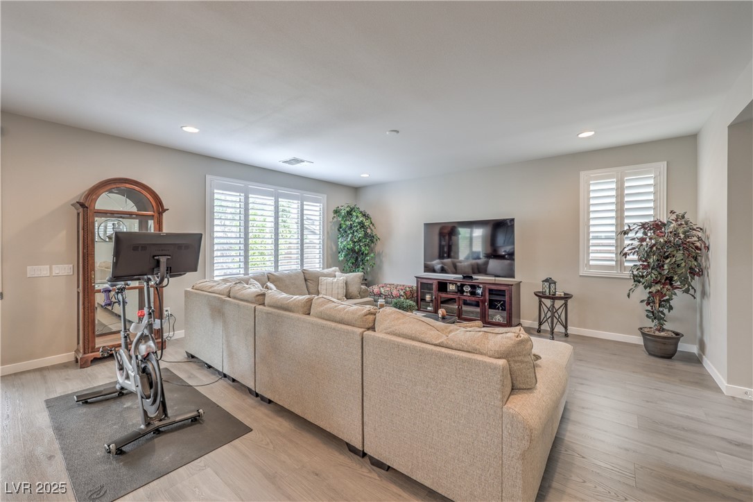 2711 Evolutionary Lane Las Vegas, NV 89138 - Photo 7 of 37 Living area featuring healthy amount of natural light, light wood-type flooring, recessed lighting, and baseboards