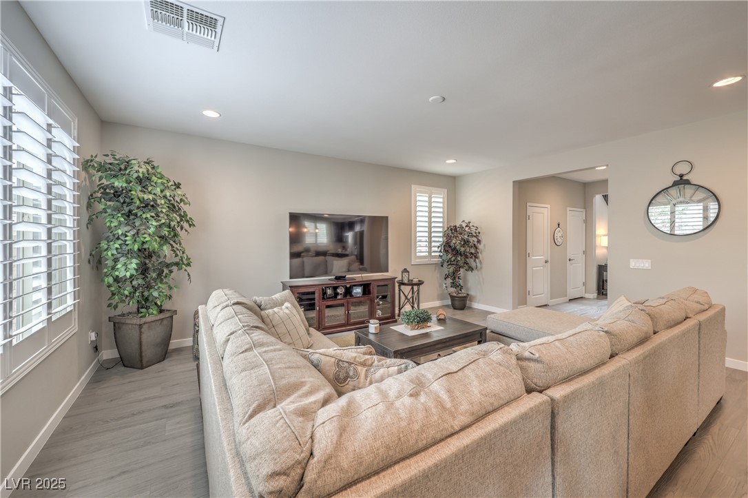 2711 Evolutionary Lane Las Vegas, NV 89138 - Photo 8 of 37 Living area with light wood-type flooring, baseboards, and recessed lighting