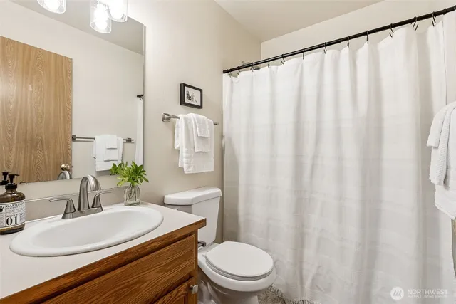 a bathroom with a toilet a sink and a mirror