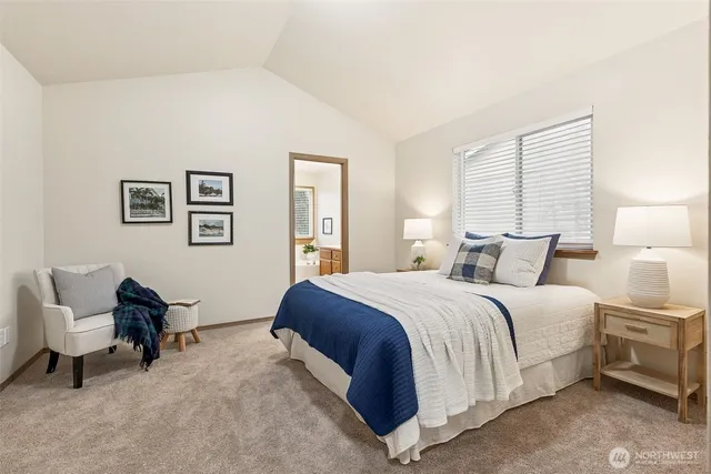 a bedroom with a bed chair and window