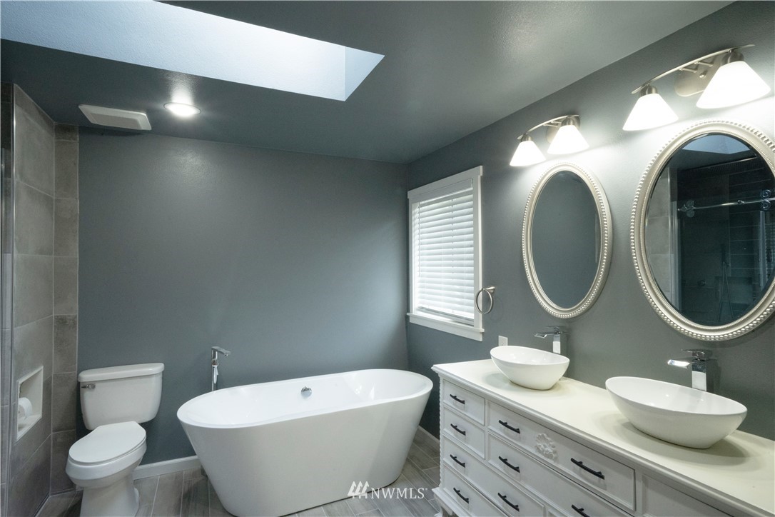 22316 6th Drive Southeast Bothell, WA 98021 - Photo 23 of 35 a bathroom with a toilet a sink and a mirror