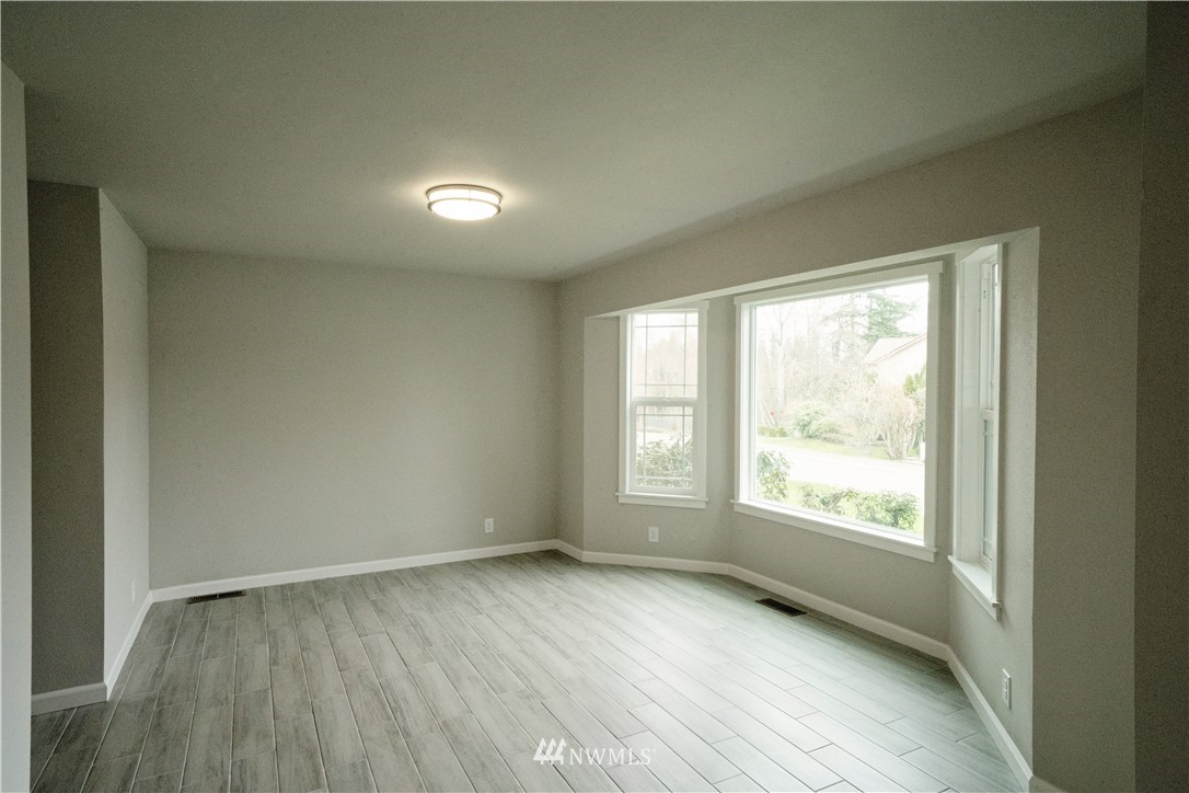 22316 6th Drive Southeast Bothell, WA 98021 - Photo 27 of 35 an empty room with wooden floor and windows