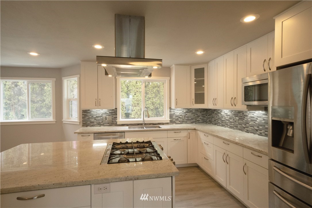 22316 6th Drive Southeast Bothell, WA 98021 - Photo 5 of 35 a kitchen with stainless steel appliances granite countertop a sink stove and refrigerator