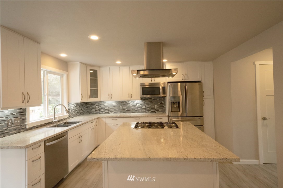22316 6th Drive Southeast Bothell, WA 98021 - Photo 6 of 35 a large kitchen with kitchen island a sink stainless steel appliances and a counter space