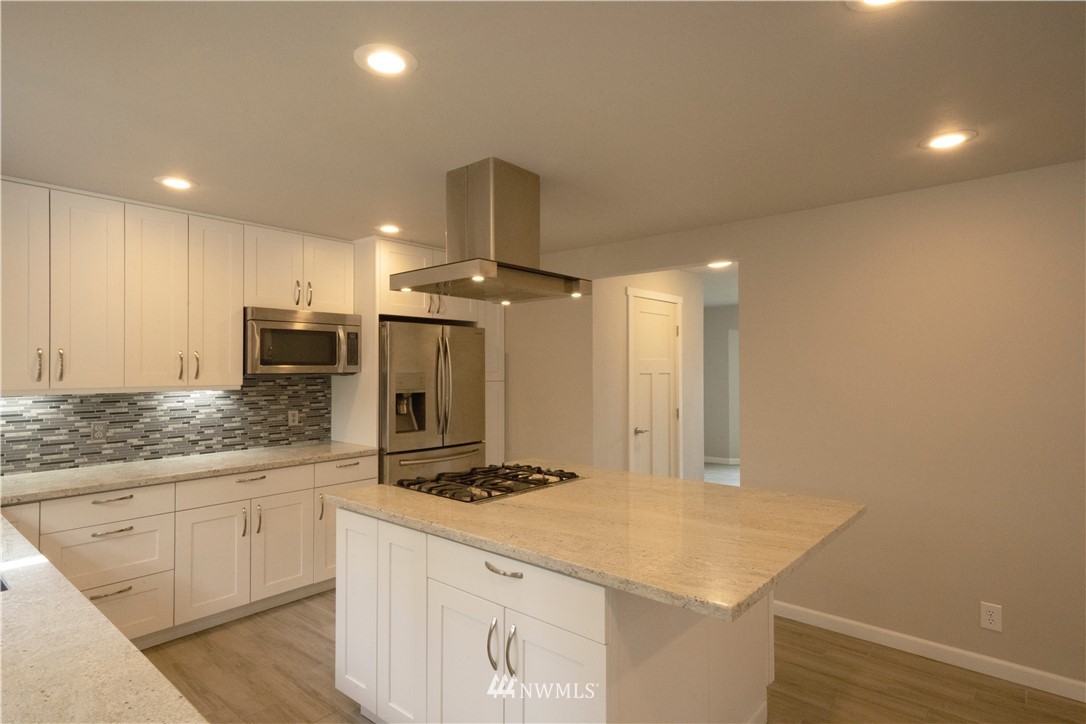22316 6th Drive Southeast Bothell, WA 98021 - Photo 7 of 35 a kitchen with a sink cabinets and wooden floor