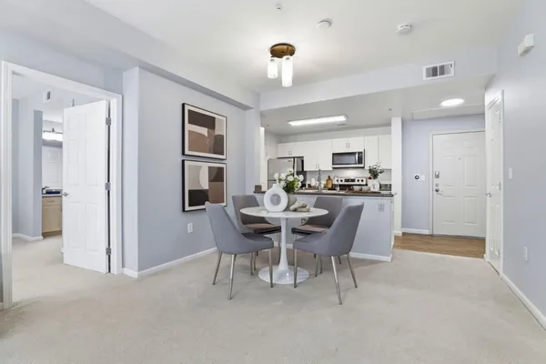 a dining room with furniture and window