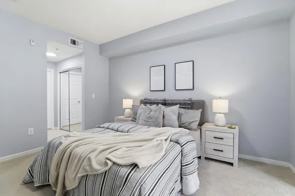 a large white bed in a white room