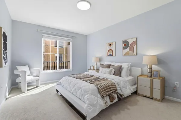 a bedroom with a bed lamp and a window